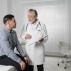 Man discussing testosterone replacement therapy with healthcare provider during consultation