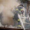 firefighter smoke exposure during active structural fire response climbing ladder into burning building