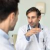 TRT timeline consultation showing physician explaining testosterone replacement therapy results to male patient