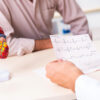 low testosterone heart health consultation showing physician reviewing heart cardiogram with male patient