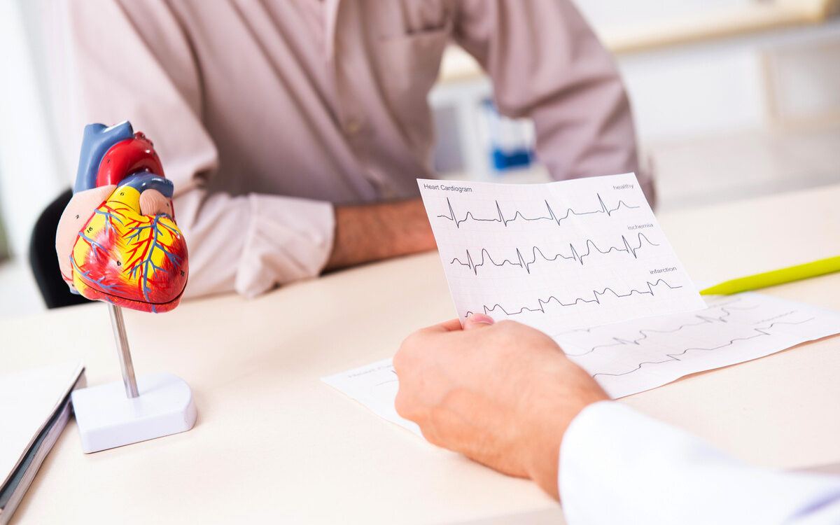 low testosterone heart health consultation showing physician reviewing heart cardiogram with male patient