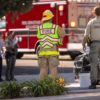 Firefighters and sheriff's deputy standing at an accident scene, representing occupational risk factors for varicose veins in first responders